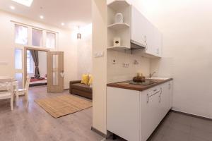 Una cocina y una sala de estar con un sofá y una mesa. en Goldcentral Apartment Comfort, en Budapest