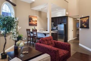 a kitchen and living room with a couch and a table at The Castle at Swan Lake in Vernon