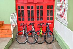 two bikes parked in front of a red door at Vintage Balcony Guesthouse & Suites in Ovar