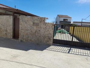 a gate to a house with a stone wall at La Vega in Tarifa