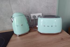 two toasters sitting on top of a wooden table at magnifique T3 bord de mer garage privé classé 3 étoiles in Collioure
