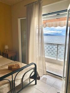 a bedroom with a bed and a view of the ocean at Αγκυροβόλιο in Ilia +15 photos