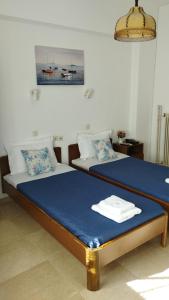 a bedroom with a bed with a blue mattress at Hotel Kima in Kamariotissa