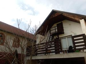 a house with a balcony and stairs on it at Le P'tit Baigneur - Balaton in Szigliget