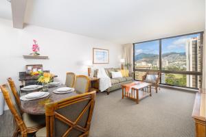 a living room with a table and a couch at Beautiful Mountain Views Condo, Parking is free! in Honolulu