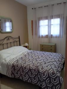 a bedroom with a large bed and a window at Villa Loma in Belicena