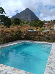 a swimming pool with a mountain in the background at Desired View in Choiseul