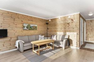 a living room with a couch and a table at Vacation apartment in Hornnes