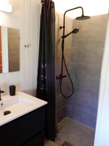 a bathroom with a shower and a sink at Holiday Home M&A in Toftlund