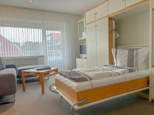 a bedroom with a bed and a living room at Haus Kleemann in Norderney