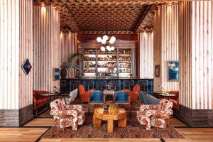 a lobby with a bar with chairs and a table at Austin Proper Hotel, a Member of Design Hotels in Austin