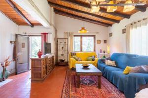 un soggiorno con divano blu e tavolo di Casa con piscina cerca de Girona a Girona