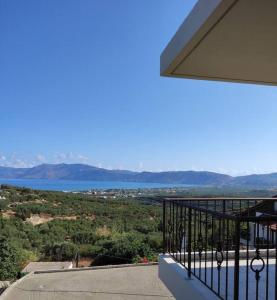 a balcony of a house with a view of the water at Fanouria's home in Kalleryianá