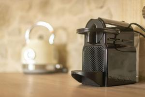 a black appliance sitting on top of a table at Fanouria's home in Kalleryianá