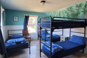 a room with three bunk beds and a window at HI Point Montara Lighthouse in Montara