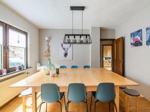 a dining room with a wooden table and chairs at Spacious holiday home with private terrace in Schmallenberg