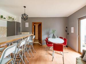 a kitchen and dining room with a white table and chairs at Spacious holiday home with private terrace in Schmallenberg