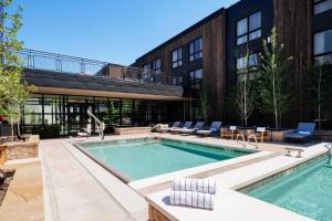 a swimming pool in front of a building at The Cloudveil, Autograph Collection in Jackson