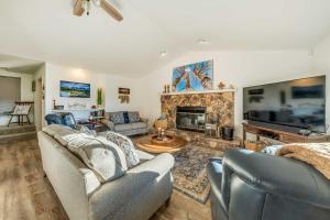 a living room with two couches and a fireplace at Wildlife Watching and Mtn Views Luxe Ruidoso Escape in Ruidoso