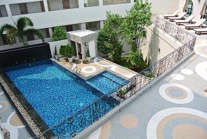 an overhead view of a swimming pool in a building at SN Plus Hotel - SHA Plus in Pattaya