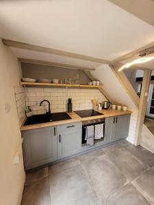 a kitchen with a sink and a counter top at Ty Golchi - Cosy traditional cottage in Corris in Corris