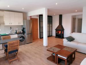 a kitchen and a living room with a stove at Las Vistas in Buendía