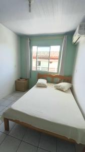 Un pat sau paturi într-o cameră la Pousada Mar Verde