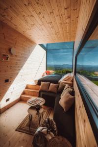 a room with a couch and a table and a window at Walden House Casarampi in Orsano
