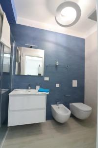 a bathroom with a sink and a toilet and a mirror at Ad un passo dal mare in Bari