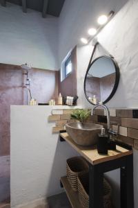 a bathroom with a sink and a mirror at Suite Swimming Pool Quinta da Eira 140 years old in Loulé
