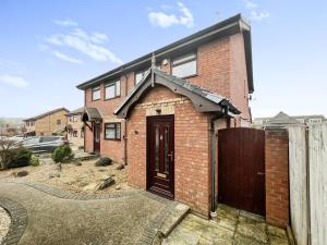 a brick house with a door and a fence at 3 Bedroom house - Sandown in Sandown