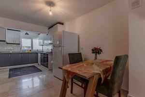 a kitchen and dining room with a table and a refrigerator at Güneş Villa in Antalya