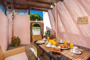 a table with food on it on a patio at Fotini's House in Lachania