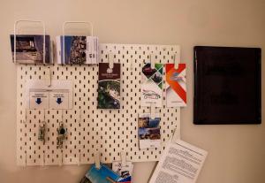 a wall with a pegboard with items on it at Attico 195 in Salerno
