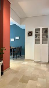 a dining room with a table and a red wall at Theseus Retreat 10 min walk from the Acropolis in Athens +23 photos