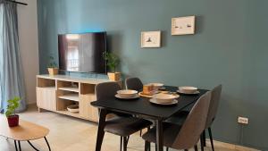 a dining room with a black table and chairs at Theseus Retreat 10 min walk from the Acropolis in Athens