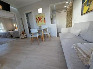 a living room with a couch and a table at Alicante Skylights Apartments in Alicante