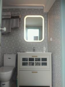 a bathroom with a white sink and a mirror at Casa 16 in Tavira +10 photos
