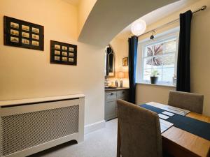 a dining room with a table and a window at Palmer House Apartment in Ryde