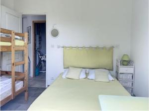 a bedroom with a large bed and a bunk bed at l'Echo des Vagues in Foulerot