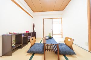 a living room with a table and chairs at Mansion Kitanomachi Room 408 - Vacation STAY 64438v in Awaji