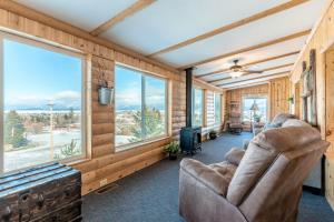 a living room with a couch and large windows at The Lake House in Polson