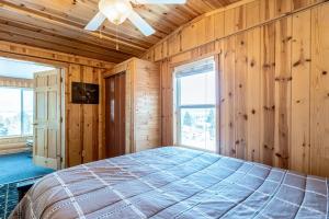 a bedroom with wooden walls and a bed in a room at The Lake House in Polson
