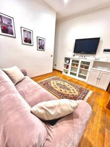 a living room with a couch and a flat screen tv at Sivy Home casa vacanze Napoli in Naples