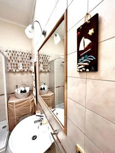 a bathroom with a sink and a mirror at Sivy Home casa vacanze Napoli in Naples
