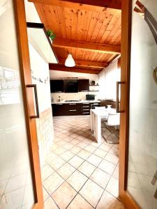 a room with a kitchen with a table in it at Sivy Home casa vacanze Napoli in Naples