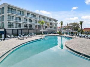 a swimming pool in front of a building at Villatel at Harbor Island Beach Club in Melbourne Beach