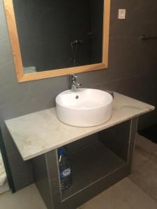 um balcão de casa de banho com um lavatório e um espelho em Apartamento T1 Moderno com Wi-Fi em Praia