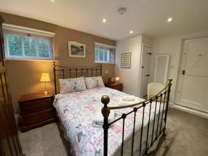 a bedroom with a bed and a table and a window at Old Droxford Station Signal Box in Soberton
