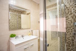 une salle de bain avec un lavabo et une douche dans l'établissement casa saloia, à Nazaré 45 autres photos